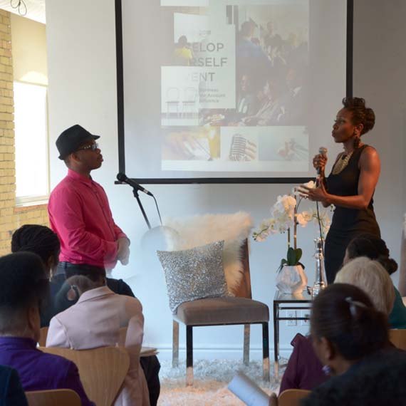 Karen coaching a participant on stage